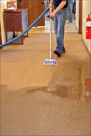 Technician extracting water from commercial property